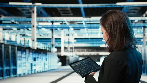 Data center programmer coding on tablet, optimizing equipment rigs Stock Footage 329332224