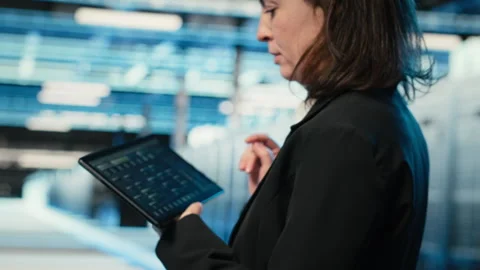 Data center programmer coding on tablet, optimizing equipment rigs Stock Footage 330100520