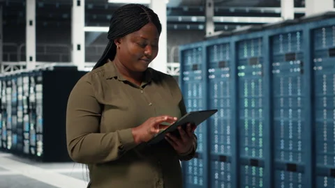 Data center programmer monitors data center metrics on tablet Stock-Footage 317125698