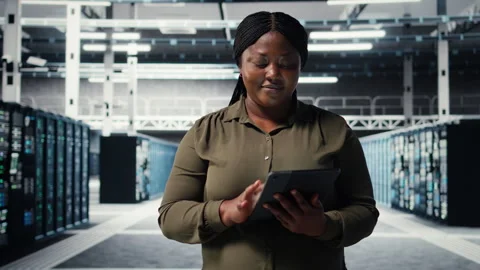 Data center programmer monitors data center metrics on tablet Stock-Footage 317204025