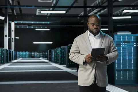 Data center programmer running error checking utilities on tablet 스톡 사진