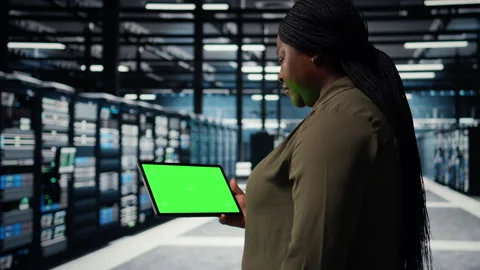 Data center programmer uses green screen tablet to minimizing downtime Stock Footage 317124056