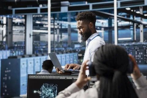 Data center programmer using AI visualization tools to identify malfunctions Stock Photos