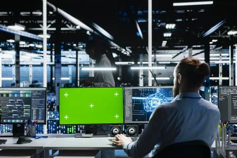 Data center programmer using green screen computer, working on databases Stock Photos