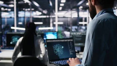 Data center programmer using laptop to monitor neural network using AI chatbot Stock Footage 313635741