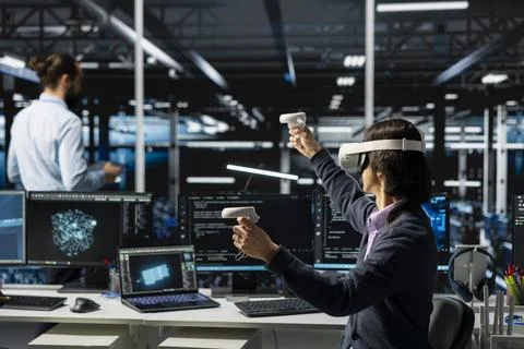 Data center programmer wearing VR goggles managing AI training datasets 스톡 사진