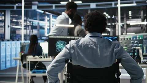 Data center programmer in wheelchair entering office uses AI node tree program Stock Footage 307020514