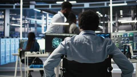 Data center programmer in wheelchair entering office uses AI node tree program Stock Footage 309506547