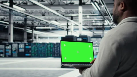 Data center programmer working on green screen laptop, updating storage Stock-Footage 311897178