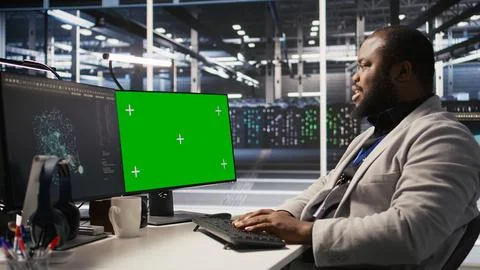 Data center programmer working on green screen desktop PC Stock Photos