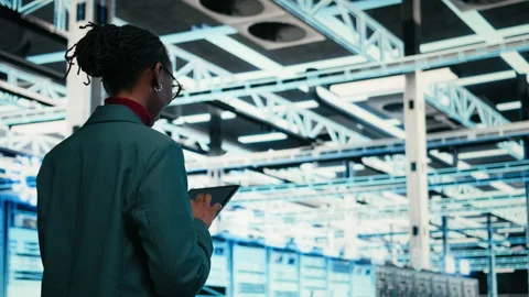 Data center programmer writing code for resource optimization using tablet Video stock 329945428