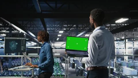 Data center programmers on industrial platform using green screen laptop 写真素材