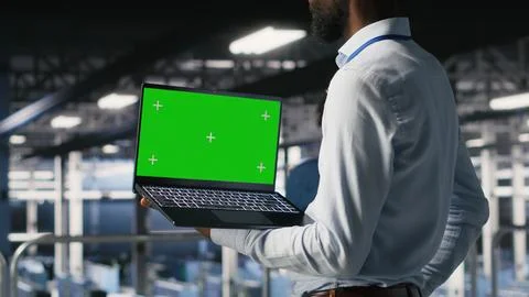 Data center programmers on industrial platform using green screen laptop 写真素材