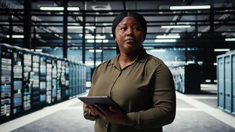 Data center software developer monitors data center metrics on tablet Stock Footage 317204187