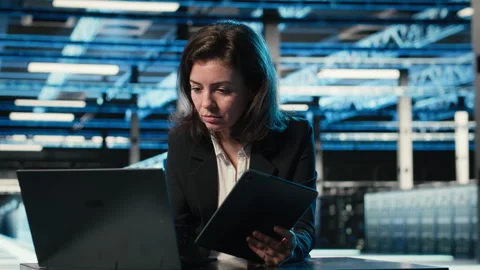 Data center software developer optimizing equipment rigs using devices Stock Footage 329326589