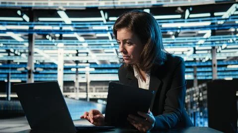 Data center software developer optimizing equipment rigs using devices Stock Photos