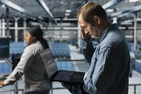 Data center software developer upset after receiving critical error on laptop Stock Photos