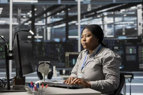 Data center software developer uses PC to update servers tech Stock Photos
