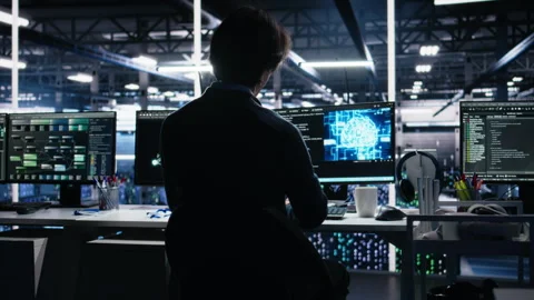 Data center software developer using computer to monitor neural network AI LLM Stock Footage 313568733
