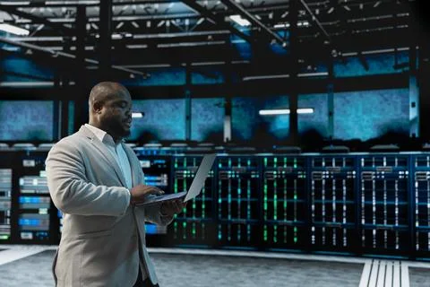 Data center software developer using laptop to protect servers 스톡 사진