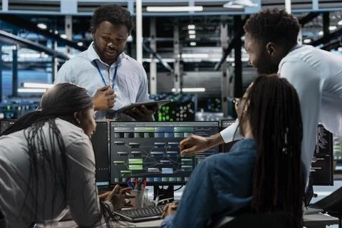 Data center software developers setting up machine learning systems Stock Photos