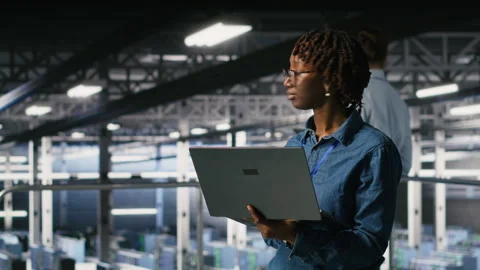 Data center software developers using devices to review AI LLM visualizations Stock Footage 310784451