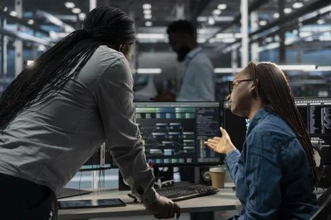 Data center software developers using PC to visualize AI neural networks Stock Photos