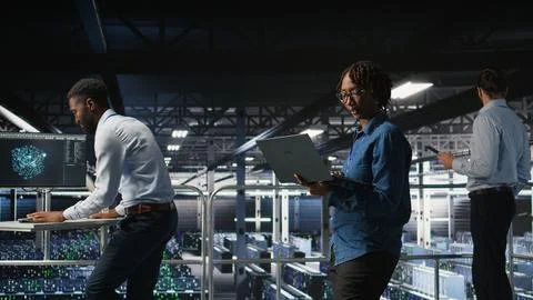 Data center software developers using devices to review AI LLM visualizations Stock Photos