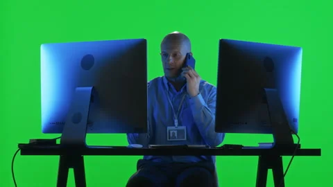 Data Center Specialist Using Phone and PC against Green Wall Stock Footage 268819692