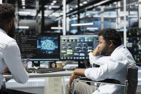 Data center supervisor and programmer with paraplegia using AI Stock Photos