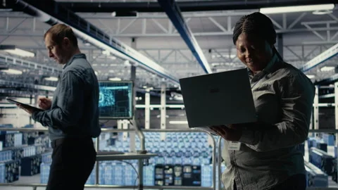 Data center supervisor on industrial platform working to improve AI rigs Stock Footage 314684348