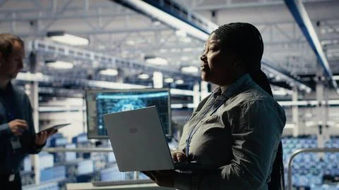 Data center supervisor on industrial platform working to improve AI rigs 写真素材