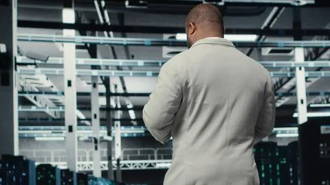 Data center system administrator checks infrastructure diagnostics using tablet 스톡 사진