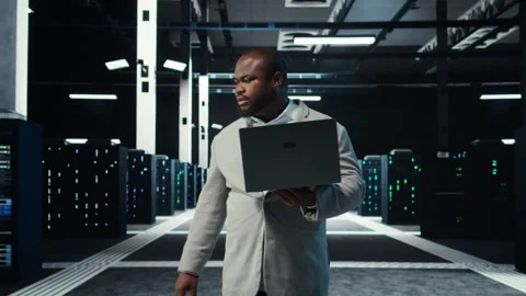 Data center system administrator coding on laptop, doing software updates Stock Footage 311959516