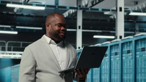 Data center system administrator reviewing code for automation scripts Stock Footage 311897389