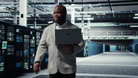 Data center system administrator reviewing code for automation scripts Stock Footage 311961330