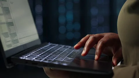 Data center system administrator using laptop to ensure error free rigs Stock Footage 317206927