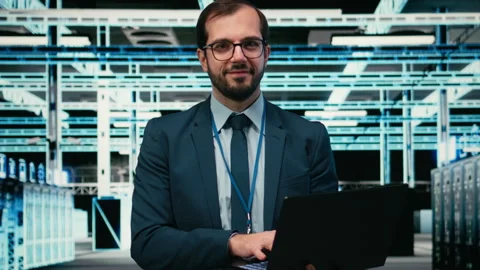 Data center system administrator using laptop to futureproof company network. Stock Footage 329452584