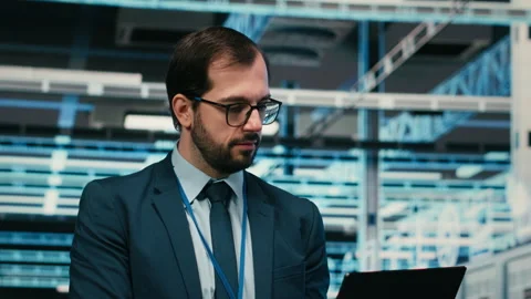 Data center system administrator using laptop to futureproof company network. Stock Footage 329713948