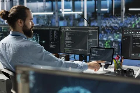 Data center system administrator using tablet, coding, managing systems Stock Photos