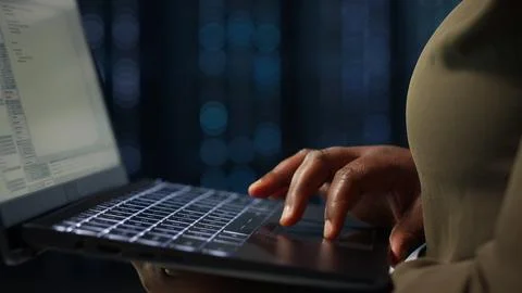 Data center system administrator using laptop to ensure error free rigs Stock Photos