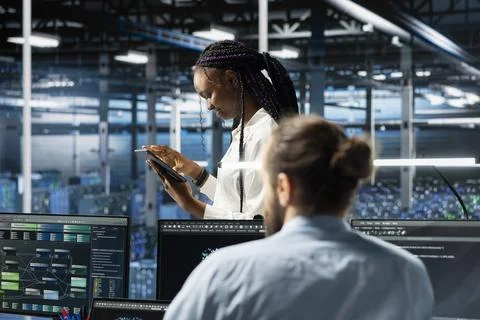 Data center system administrator working on databases supporting AI applications Stock Photos