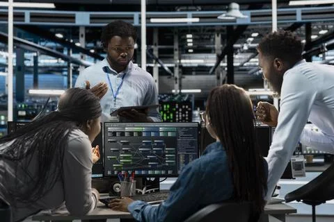 Data center system administrators using PC to visualize AI neural networks Stock Photos