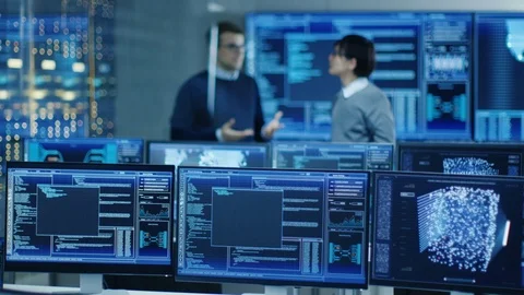 In the Data Center System Control Room Monitors Show Work Done on Neural Network Stock Footage