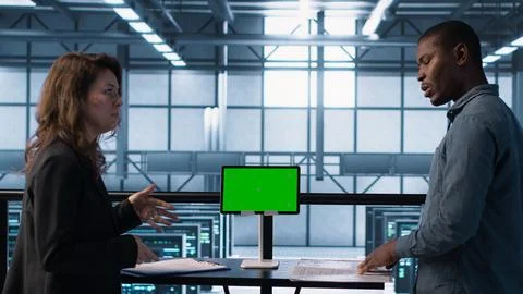 Data center team using mockup green screen tablet, reviewing paperwork 스톡 사진