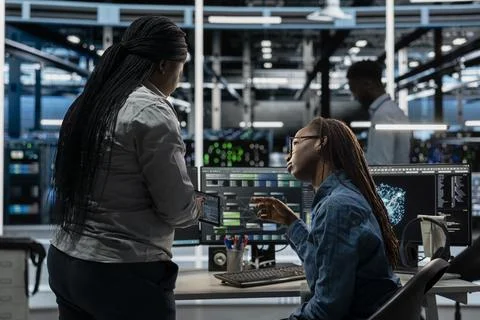 Data center team working together, using AI visualization tool Stock Photos