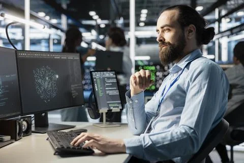 Data center technician analyzing software logs metrics on PC Stock Photos