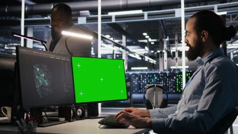 Data center technician doing software updates using green screen mockup computer Video stock 309639933