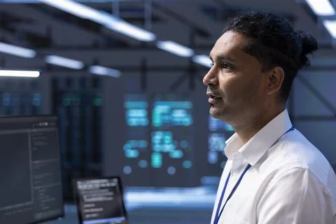 Data center technician doing yearly maintenance checkup using PC Foto stock