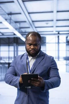 Data center technician ensuring safety and security of database using tablet Stock Photos